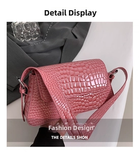 Detailed close-up of pink crocodile pattern embossing on glossy faux leather handbag