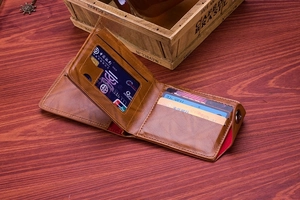 Detail of vintage brown leather wallet with multiple card slots and clear ID window