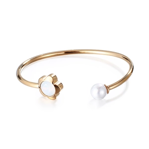 Golden flower and pearl open cuff bracelet for women featuring an elegant C-shaped design