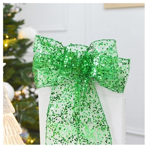 Close-up of green sequined Christmas bow topper with mesh texture on holiday tree