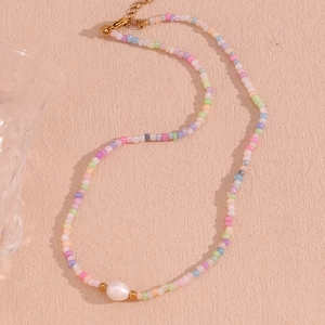 Detailed shot of handmade colorful seed beads and a baroque pearl on a golden necklace