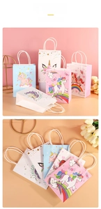 Detail of colorful cartoon unicorn gift bags with white handles and rainbow patterns