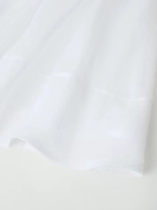 Close-up of white semi-transparent textured fabric with detailed stitching and soft mesh