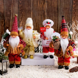 Standing Santa Claus figurines in red and gold outfits with festive winter background