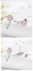 Macro detail of donut and fork cartilage stud with pink enamel and sparkling zircon stones