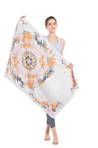 Detailed texture of microfiber beach towel with vibrant orange mandala floral print pattern