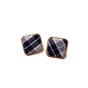 Boucles d'oreilles carrées dorées avec insert en tissu écossais bleu sur fond blanc