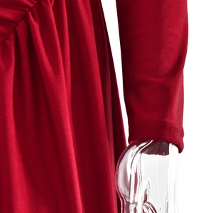 Detailed view of wine red dress featuring ruched waist and long sleeve cuffs