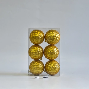 Close-up of six 10cm gold Christmas ornaments with quilted glitter texture in a box