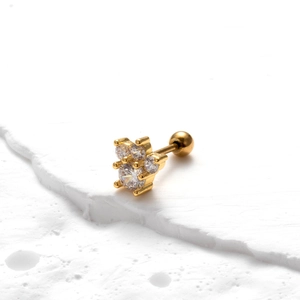 Macro shot of gold-plated clover stud earring with triple zircon inlay and screw ball back
