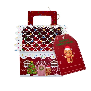 Detail of Christmas gingerbread house candy box with red handle and Merry Christmas tag