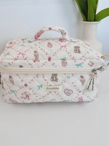 Quilted floral bear pattern cream cosmetic bag with handle and zipper ribbon detail