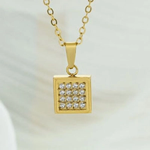 Macro shot of gold square pendant with sixteen round clear cubic zirconia stones