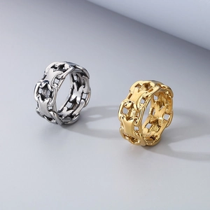 Detail shot of hollow X-shaped chain rings in gold and silver stainless steel finishes