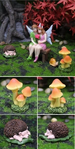 Close-up of resin hedgehog and mushroom figurines in a fairy garden landscape