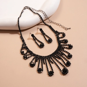 Detail view of vintage fringe necklace and earrings set with black rhinestones
