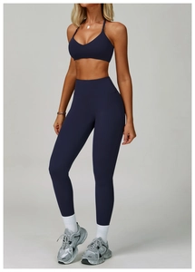 Detail of high-waisted navy blue yoga set featuring a backless sports bra and leggings