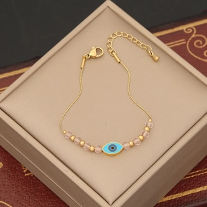 Bracelet doré bohème avec breloque œil bleu maléfique et perles en cristal rose