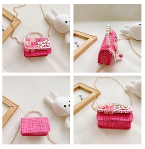 Detail view of pink tweed kids handbag with pearl handle and 3D floral accents