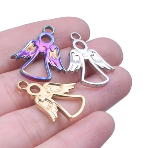 Detailed macro of stainless steel angel charms in gold, silver and rainbow finishes