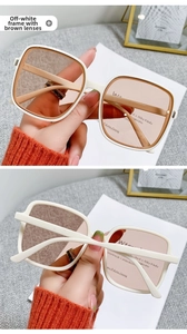 Detail of cream white square sunglasses with brown lenses and elegant side studs