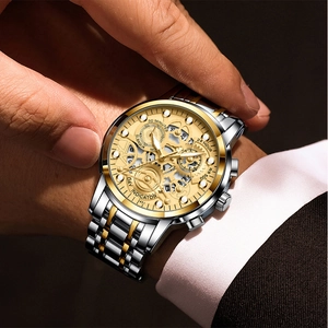 Macro shot of gold and silver steel men's watch with skeleton dial and multifunction hands