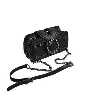 Fashionable black crossbody bag with rivet details, rhinestone buckle, and chain strap