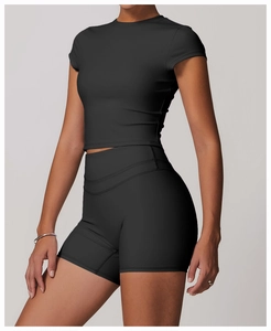 Detail of black moisture-wicking yoga set featuring cropped short sleeve top and shorts