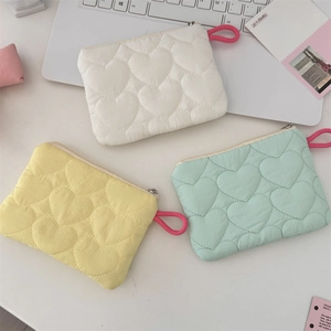 Quilted fabric pouches in candy colors with heart patterns and zipper detail
