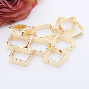 Macro shot of 14K gold-filled square bead covers with side holes for DIY jewelry making