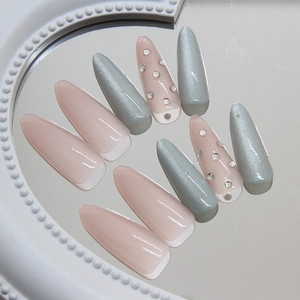 Pink and mint green cat-eye stiletto press-on nails with sparkling rhinestones set