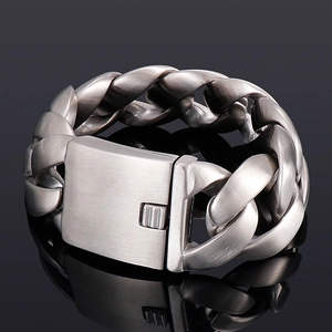 Macro shot of silver stainless steel Cuban link bracelet with wide square clasp detail