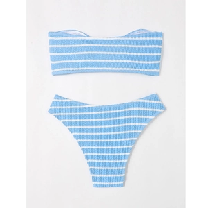 Flat lay of light blue and white striped seersucker bikini set on beige background