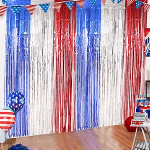 Detailed setup of patriotic fringe curtain backdrop with star banners and balloons