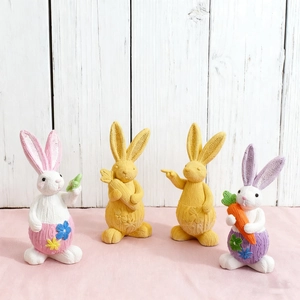 Detailed knit texture on 4-piece Easter bunny resin set holding flowers and carrots