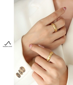 Detail of vintage sun and moon embossed texture on 18K gold-plated stainless steel ring