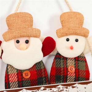 Close-up of plush Santa and Snowman ornaments featuring plaid fabric and burlap hats