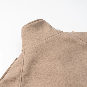 Detail shot of camel wool coat stand collar with high-quality fabric texture and stitching