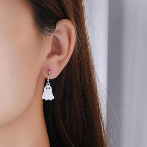 Ghost dangle earrings in white finish worn by a model for a festive party look