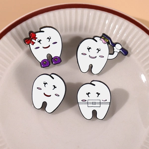 Cartoon tooth enamel pin set with toothbrush and braces on white ceramic plate