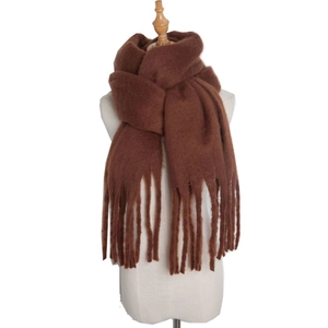 Detailed view of soft brown mohair scarf featuring long fringe tassels on white background