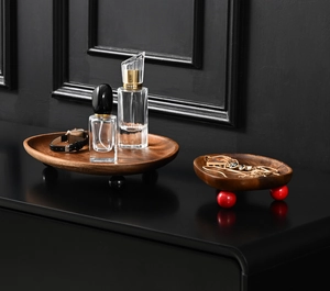 Detail of walnut wood tray set with round feet for keys jewelry and perfume storage