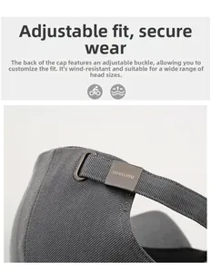 Detail of adjustable metal buckle and grey twill cotton fabric on a baseball cap
