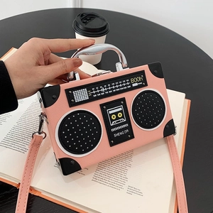 Pink vintage radio shaped crossbody bag with metal handle and FM dial design