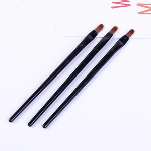 Detailed close-up of three black silicone lip brushes with brown bristles on white background
