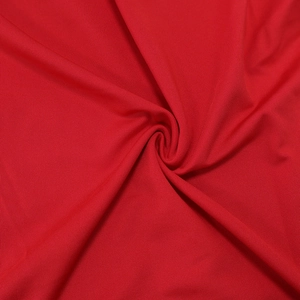 Macro detail of red ruched fabric texture with a soft sheen for women's summer dresses