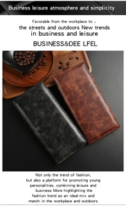 Close-up of vintage textured leather long wallets in black and brown on a wooden tray