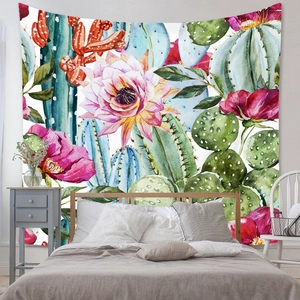 Detail of bohemian tapestry featuring watercolor cactus and pink flowers on bedroom wall