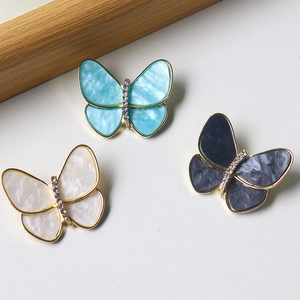 Elegant butterfly brooches with acetate wings and gold alloy details in three colors