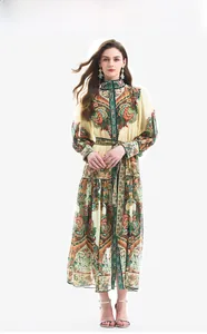 Detail of vintage paisley print dress featuring lantern sleeves and floral patterns